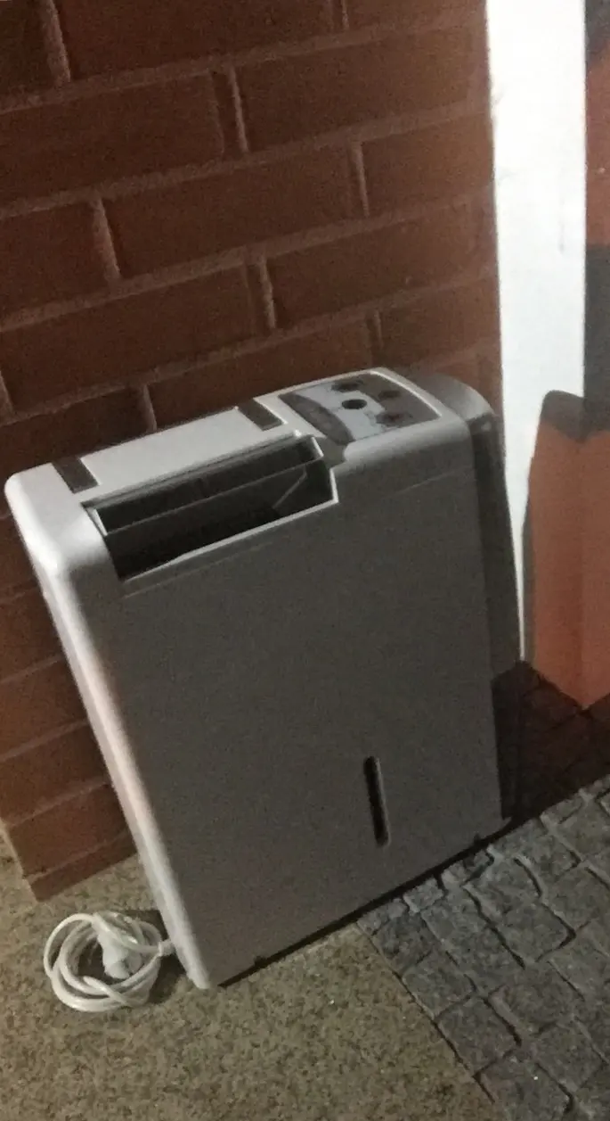A portable dehumidifier set up to dry a room. Shown on the homepage for Syracuse, NY.
